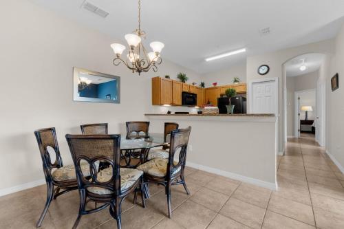 a dining room and kitchen with a table and chairs at A hidden Gem in plain sight in Orlando