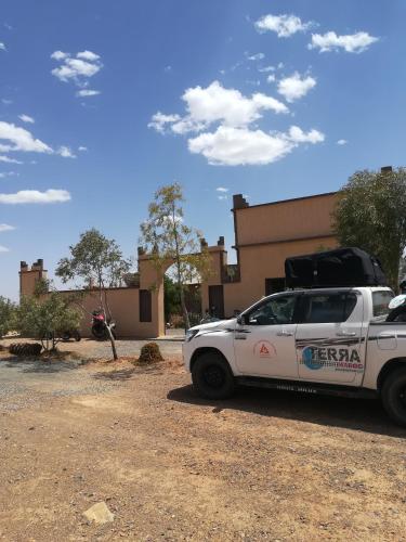 a white car parked in front of a building at Gite Amoudou in Ouarzazate