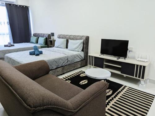 a living room with a couch and a bed at Core Soho Suit Kip Sentral Kotawarisan Family Studio Near KLIA & KLIA2 in Sepang