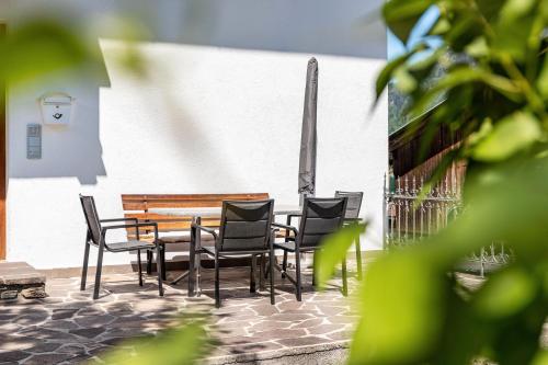 a wooden table and chairs next to a bench at Studio Hochzillertal mit Sauna in Ried im Zillertal