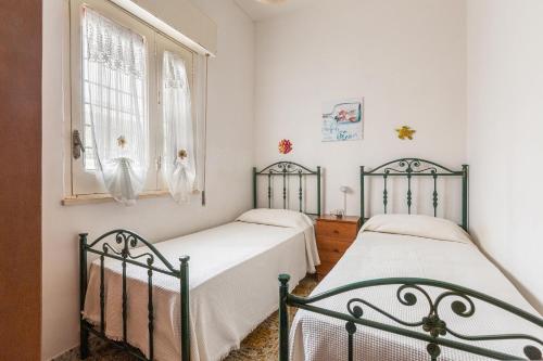 En eller flere senge i et værelse på Villetta Isla Bonita by BarbarHouse