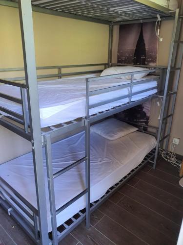 quelques lits superposés dans une chambre dans l'établissement Duplex Vue sur Mer et Pieds dans l'eau Plage de Pramousquier, au Lavandou