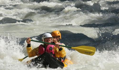 two people on a raft in the water at Chalet Pitu - 1-6 People in Vénosc