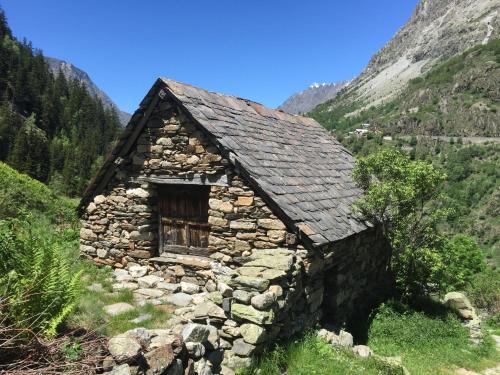 an old stone building on a hillside in the mountains at Chalet Pitu - 1-6 People in Vénosc