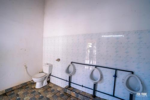 a bathroom with two urinals and a toilet at Riverside Hotel in Katunayake