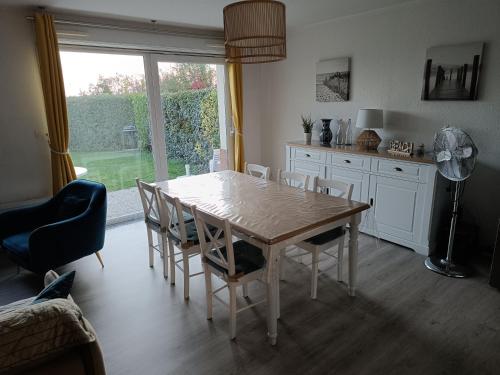 - une table à manger et des chaises dans la cuisine dans l'établissement Au cœur de la baie de canche entre terre et mer, à Étaples