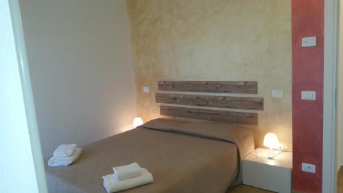 a bedroom with a bed with two towels on it at Appartamento Villa Ivan in Lazise