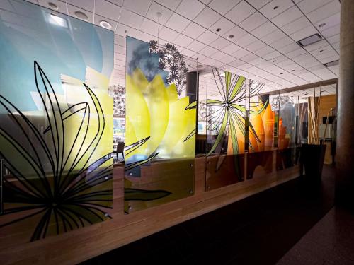a wall with paintings of plants on it at Coast Chilliwack Hotel by APA in Chilliwack