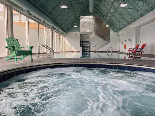 a swimming pool with a green chair in the middle at Coast Chilliwack Hotel by APA in Chilliwack