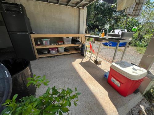 a patio with a table and a table and a grill at Pura Vida Jungle Retreat - Montezuma in Montezuma
