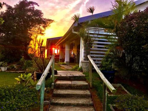 a house with stairs leading to the front yard at Platinum View Ocean Breeze in Widenham