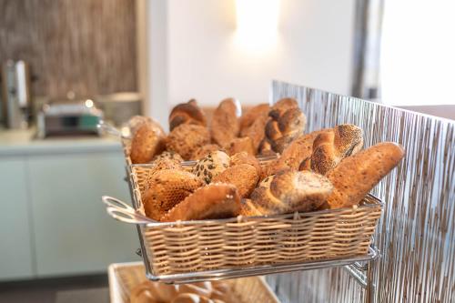 a basket of bagels and carrots in a kitchen at Hotel Ganslhof - Adults only in Salzburg