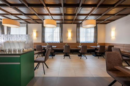 a large dining room with a long table and chairs at Hotel Ganslhof - Adults only in Salzburg