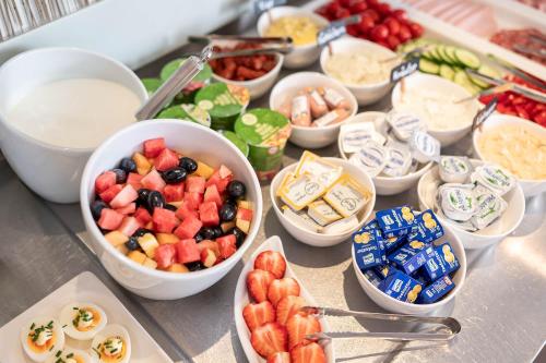 a buffet of food with bowls of fruit and snacks at Hotel Ganslhof - Adults only in Salzburg