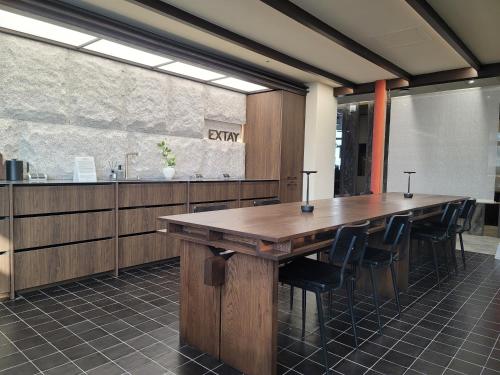 a conference room with a large wooden table and chairs at Extay Dongdaemun in Seoul