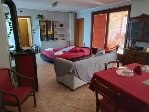 a living room with a couch and a bed at Bed & Breakfast Milù in Cuneo