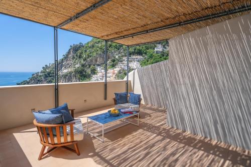 a balcony with a table and chairs and the ocean at Villa Romito - Sea view, central location in Positano