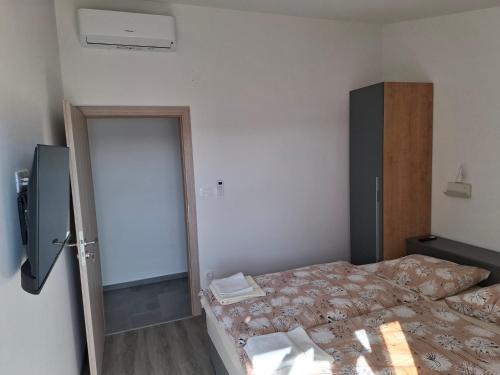 a room with two beds and a door to a bedroom at MIRKO DIVING CENTER in Rab