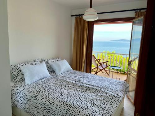 a bedroom with a bed and a view of the ocean at Podaca Holiday House with Sea View in Podaca