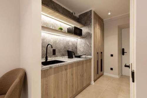 a kitchen with a sink and a counter at The First Apart Hotel in Almaty