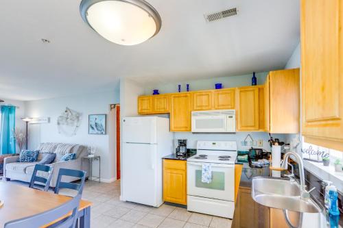 a kitchen with yellow cabinets and a white refrigerator at Cozy Middle Bass Island Getaway On Lake Eerie! in Put-in-Bay