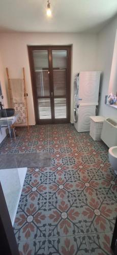 a kitchen with a tile floor and a refrigerator at Heavenly Abode - Barbaresco in Barbaresco
