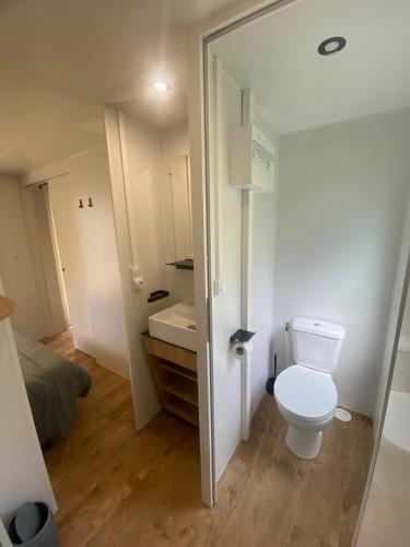 a small bathroom with a toilet and a sink at Camping maeva Escapades Colomba in Olmeto