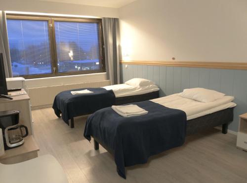 Ένα ή περισσότερα κρεβάτια σε δωμάτιο στο Finlandia Hotel Puu-Juuka