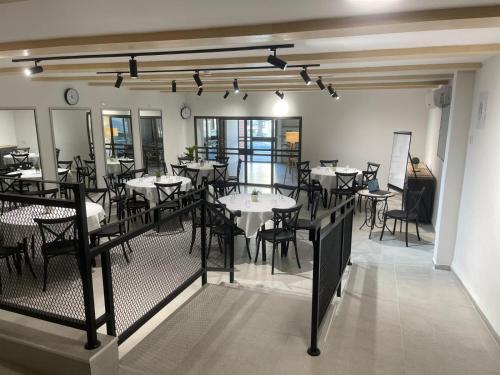 a restaurant with tables and chairs in a room at Astoria Galilee Hotel in Tiberias