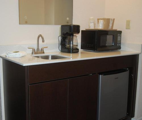 a kitchen counter with a sink and a microwave at Vacation Lodge in Pigeon Forge
