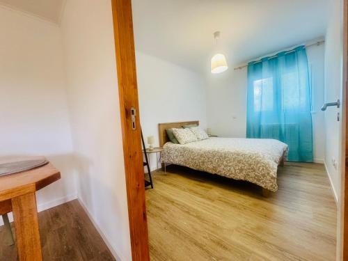 a small bedroom with a bed and a window at Casa do Sobreiro in Cantanhede