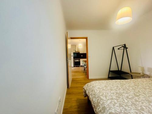 a bedroom with a bed and a room with a hallway at Casa do Sobreiro in Cantanhede