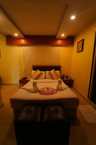 a bedroom with a large bed in a room at Hotel Diamonds Pearl in Visakhapatnam