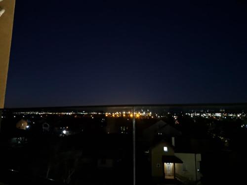 a view of a city at night with lights at RIO Apartment in Petrovec