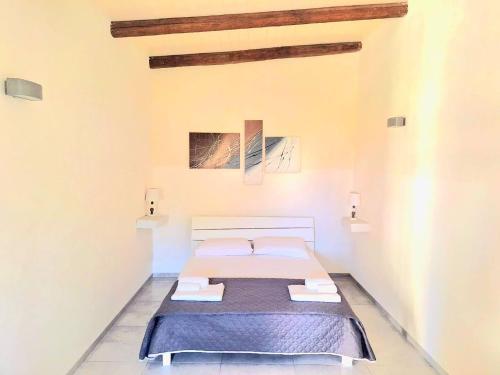 a bedroom with a bed with two towels on it at La depandance Villa Edo in Marsala