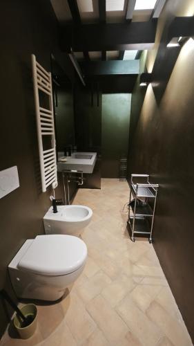 a bathroom with a toilet and a sink in it at Agriturismo Pieve San Biagio - Adults Only in Macerata