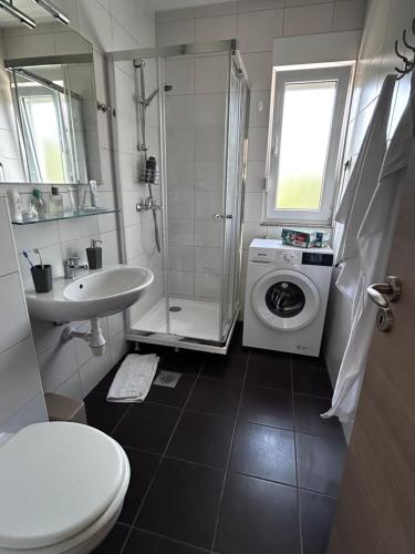 a bathroom with a toilet sink and a washing machine at Apartment Milna Dante in Milna