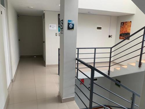 a hallway with a staircase in a building at Arum Hotel & cafebar in Cabanaconde