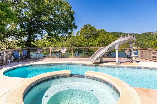 a swimming pool with a slide in the middle at Artilla Cove Cabin 6 -Lake views- Pool & Hot Tub in Branson