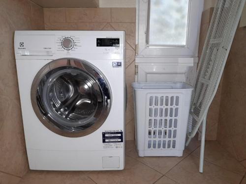 a washer and dryer in a room with a window at Apartament Dzintari in Jūrmala