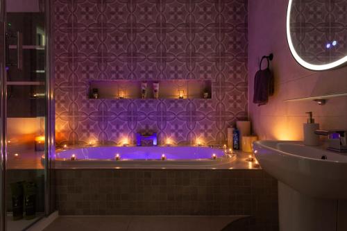 a bathroom with a tub with lights in it at Bradford Luxury Central Apartment with Jacuzzi in Bradford