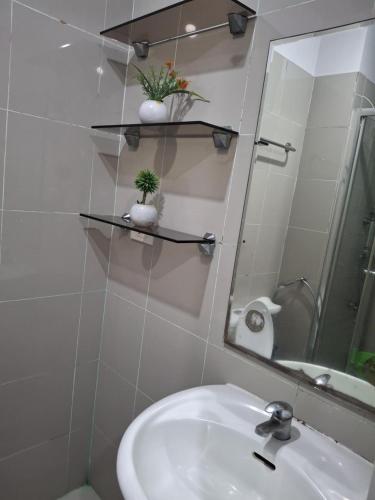 a bathroom with a sink and a mirror at grass residences tower2 21Floor in Manila