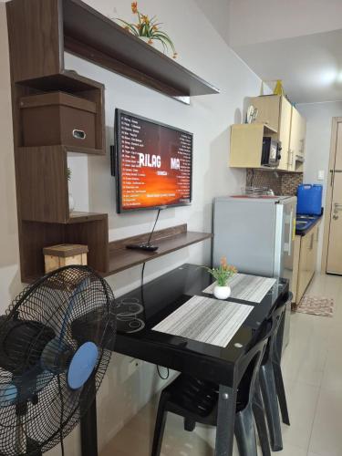 a kitchen with a desk with a computer on the wall at grass residences tower2 21Floor in Manila