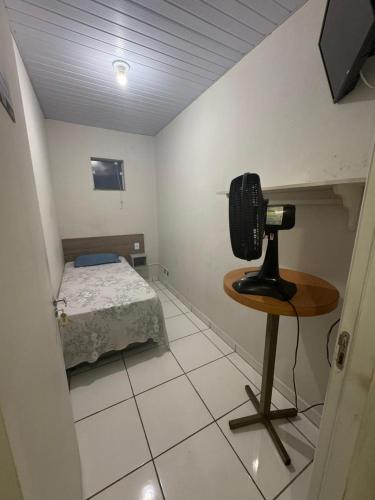 a room with a camera and a bed in it at Hostel Senhor do Café in Botucatu