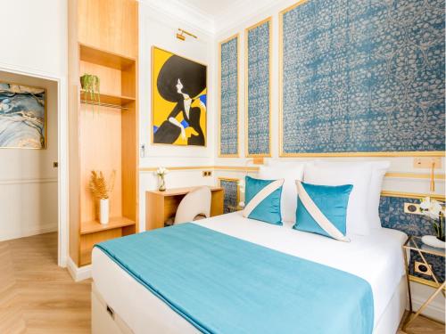 une chambre avec un lit bleu et blanc et des tableaux dans l'établissement Merveil - Luxury Suite -Opera - Volney I, à Paris