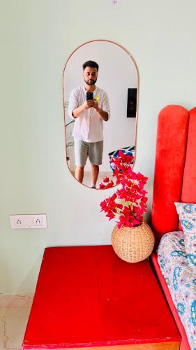 a man taking a picture of himself in a mirror at Dhyani Residence in Nakraunda