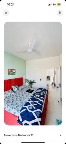 a bedroom with a bed and a red couch at Dhyani Residence in Nakraunda