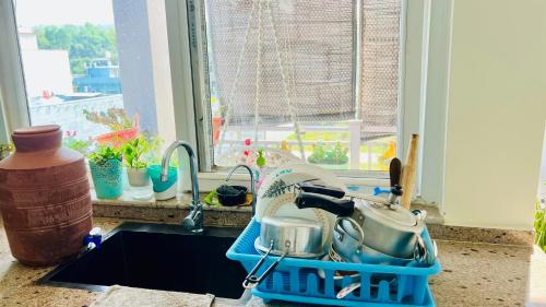 a kitchen sink with pots and pans in a dish rack at Dhyani Residence in Nakraunda