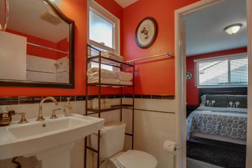 a bathroom with a sink and a toilet and a bed at F-24 Mickeys House in Anaheim
