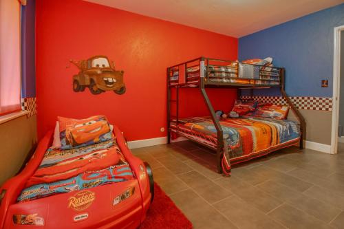 two bunk beds in a room with red walls at F-24 Mickeys House in Anaheim